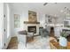 Living room view with fireplace and grey chairs open to a kitchen with stainless appliances at 2320 Edgar Park Pl # 95, Duluth, GA 30096