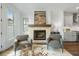 Cozy living room featuring a stone fireplace and gray armchairs at 2320 Edgar Park Pl # 95, Duluth, GA 30096