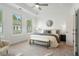 Bright, spacious primary bedroom featuring a tray ceiling, neutral decor, and ample natural light at 2320 Edgar Park Pl # 95, Duluth, GA 30096