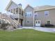 A beautiful backyard featuring a screened porch, an ample lawn and patio at 283 Harmony Lake Dr, Canton, GA 30115