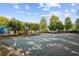 A community basketball court surrounded by lush trees, providing a great recreation space at 283 Harmony Lake Dr, Canton, GA 30115