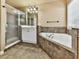 Bathroom with glass shower enclosure and a standalone tub at 283 Harmony Lake Dr, Canton, GA 30115