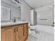 Traditional bathroom featuring a wooden vanity with light countertops, tiled shower and floors at 283 Harmony Lake Dr, Canton, GA 30115