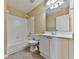 Bathroom featuring a shower-over-tub combo, toilet, and single vanity sink at 283 Harmony Lake Dr, Canton, GA 30115