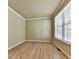 A simply decorated, sunlit bedroom with hardwood floors and neutral walls provides a calm and serene space at 283 Harmony Lake Dr, Canton, GA 30115