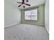 This is a bedroom featuring a ceiling fan and a big window allowing plenty of light at 283 Harmony Lake Dr, Canton, GA 30115