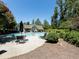 Community pool area with lounge chairs and umbrella shaded tables at 283 Harmony Lake Dr, Canton, GA 30115
