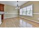 Sunny dining area features hardwood floors, chandelier lighting, and bright windows at 283 Harmony Lake Dr, Canton, GA 30115