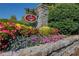 Community entrance with stone signage surrounded by colorful flowers and lush greenery at 283 Harmony Lake Dr, Canton, GA 30115