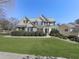 Beautifully landscaped front yard and classic brick facade enhance the curb appeal of this two-story home at 283 Harmony Lake Dr, Canton, GA 30115