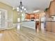A bright kitchen has wood cabinets, hardwood floors and a pass-through to the living room at 283 Harmony Lake Dr, Canton, GA 30115