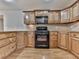 Well-equipped kitchen featuring a gas range, wooden cabinets, and ample counter space at 283 Harmony Lake Dr, Canton, GA 30115