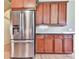 A kitchen featuring wood cabinetry, stainless steel appliances, and light hardwood flooring at 283 Harmony Lake Dr, Canton, GA 30115