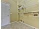 A well-organized laundry room with shelving and tile flooring awaits in this home at 283 Harmony Lake Dr, Canton, GA 30115