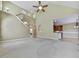 A very spacious living room features a stairway, vaulted ceiling, and an arched opening to the kitchen at 283 Harmony Lake Dr, Canton, GA 30115