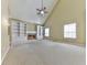 Spacious living room with fireplace, built-in bookcases, and a vaulted ceiling. Carpeted throughout at 283 Harmony Lake Dr, Canton, GA 30115