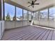 Covered porch featuring a wooden floor and screened windows with a view to the backyard at 283 Harmony Lake Dr, Canton, GA 30115