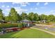 Entrance to a lush community featuring landscaped islands and charming entryways at 283 Harmony Lake Dr, Canton, GA 30115