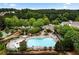 Aerial view of a community pool with lounge chairs and lush landscaping at 283 Harmony Lake Dr, Canton, GA 30115
