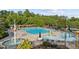 A beautiful swimming pool and splash pad area are surrounded by lounge chairs and umbrellas at 283 Harmony Lake Dr, Canton, GA 30115
