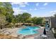An inviting kidney-shaped pool is surrounded by ample lounge chairs and mature landscaping at 283 Harmony Lake Dr, Canton, GA 30115