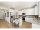 Bright kitchen featuring stainless steel appliances, a center island with seating, and white cabinetry at 111 Maplewood Ln, Conyers, GA 30094