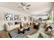 Bright open-concept living room with hardwood floors and stainless steel appliances in the kitchen at 111 Maplewood Ln, Conyers, GA 30094