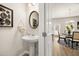 Powder room with a white sink and view into the kitchen at 111 Maplewood Ln, Conyers, GA 30094