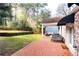 Backyard with a brick patio, a covered porch, and a grassy area at 2911 N Hills Ne Dr, Atlanta, GA 30305