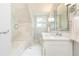 Bathroom with a glass shower door, marble wall tiles, and a double sink vanity at 2911 N Hills Ne Dr, Atlanta, GA 30305