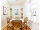 Cozy breakfast nook with built-in shelves, a round table, and wicker chairs at 2911 N Hills Ne Dr, Atlanta, GA 30305