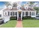 Charming brick home with dormers, black shutters, brick walkway, and well-manicured lawn and landscaping at 2911 N Hills Ne Dr, Atlanta, GA 30305