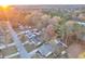 Aerial shot of a neighborhood surrounded by lush, colorful trees and a quiet, winding road at 3109 Meadow Wood Ct, Lawrenceville, GA 30044