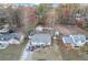 An aerial view shows a house with detached garage and spacious backyard in a wooded neighborhood with fall colors at 3109 Meadow Wood Ct, Lawrenceville, GA 30044