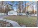 Spacious backyard with lush grass, storage building, white fence and playground at 3109 Meadow Wood Ct, Lawrenceville, GA 30044