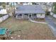 Backyard featuring a covered porch and a large grassy area with a playground at 3109 Meadow Wood Ct, Lawrenceville, GA 30044