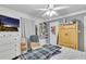 Cozy bedroom with ceiling fan, tv, and white dresser and hardwood floors at 3109 Meadow Wood Ct, Lawrenceville, GA 30044