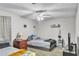 Cozy bedroom featuring neutral walls, ceiling fan, patterned carpet, and two beds at 3109 Meadow Wood Ct, Lawrenceville, GA 30044