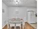 Bright dining area features a table with four chairs and hardwood floors at 3109 Meadow Wood Ct, Lawrenceville, GA 30044