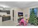 Galley kitchen with black cabinets, tile floor, and Christmas tree at 3109 Meadow Wood Ct, Lawrenceville, GA 30044