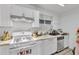 Bright kitchen features white cabinets, tile floors, and stainless steel appliances at 3109 Meadow Wood Ct, Lawrenceville, GA 30044