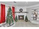 Cozy living room with a fireplace, built-in shelves, and a beautifully decorated Christmas tree at 3109 Meadow Wood Ct, Lawrenceville, GA 30044