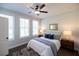 Cozy bedroom with a queen-sized bed, stylish nightstands, lamps, and a ceiling fan at 604 Goldsmith Ct # 115, Johns Creek, GA 30022