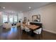 Dining area adjacent to living room with stylish furniture, decor, and hardwood floors at 604 Goldsmith Ct # 115, Johns Creek, GA 30022