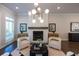 Bright living room with white brick fireplace, statement lighting, and elegant decor at 604 Goldsmith Ct # 115, Johns Creek, GA 30022