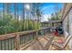 Inviting wooden back deck perfect for relaxing, with views of the lush, mature landscaping and screened-in porch at 6106 Misty Valley Se Dr, Acworth, GA 30102