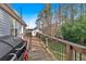 Inviting wooden back deck with a barbecue grill, perfect for outdoor cooking and overlooking the spacious backyard at 6106 Misty Valley Se Dr, Acworth, GA 30102