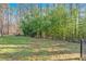 Lush green lawn with fencing for security, and mature trees offering shade and privacy at 6106 Misty Valley Se Dr, Acworth, GA 30102