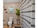 Neutral bathroom with a large plant and shower featuring a decorative curtain at 6106 Misty Valley Se Dr, Acworth, GA 30102