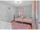 Bedroom with twin beds, pink rug, and windows with pink curtains at 6106 Misty Valley Se Dr, Acworth, GA 30102